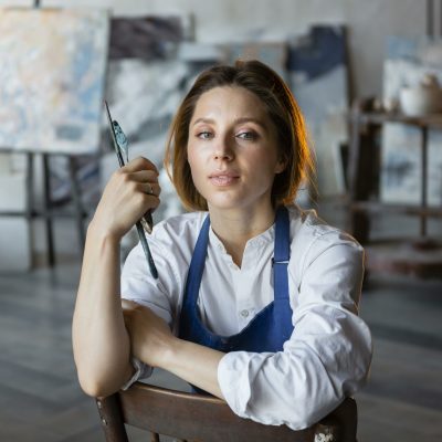 medium-shot-woman-holding-painting-tools